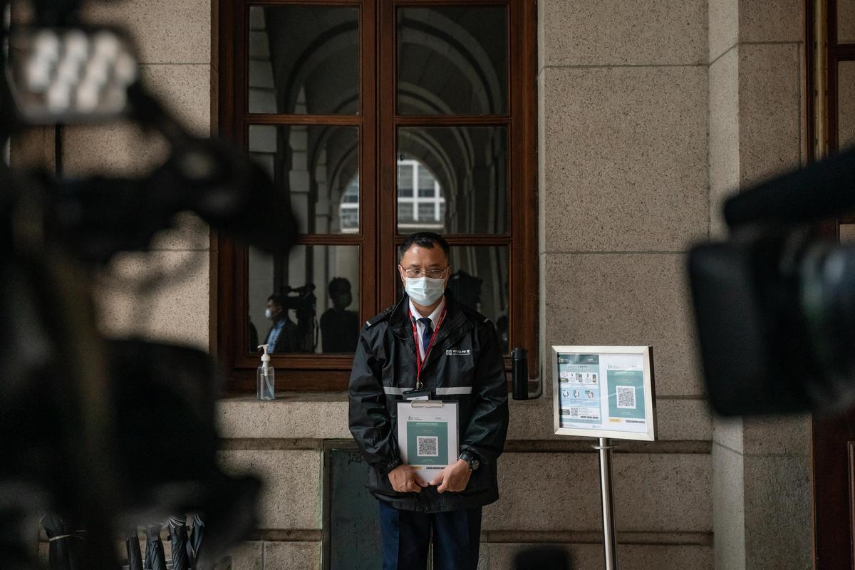 A security guard holds a QR code for the LeaveHomeSafe Covid-19 contact-tracing app at the Final Court of Appeal ahead of a ceremony to mark the opening of the legal year on January 24, 2022, in Hong Kong, China. (Anthony Kwan/Getty Images)