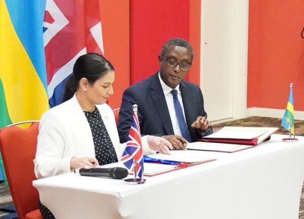 Then-Home Secretary Priti Patel and Rwandan Foreign Minister Vincent Biruta sign a "world-first" migration and economic development partnership in Kigali, Rwanda, on April 14, 2022. (Flora Thompson/PA)