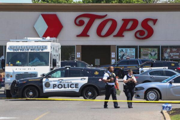 Police walk outside the Tops grocery store in Buffalo, N.Y., on May 15, 2022. (Joshua Bessex/AP Photo)