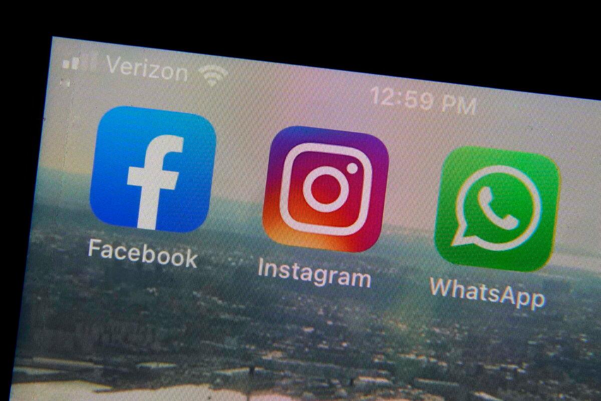 The mobile phone apps for Facebook (L), Instagram (C), and WhatsApp on a device in New York. (Richard Drew/AP Photo)