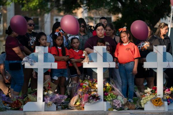People gather at a memorial site to pay their respects to the victims killed in the elementary school shooting in Uvalde, Texas, on May 26, 2022. (Jae C. Hong/AP Photo)