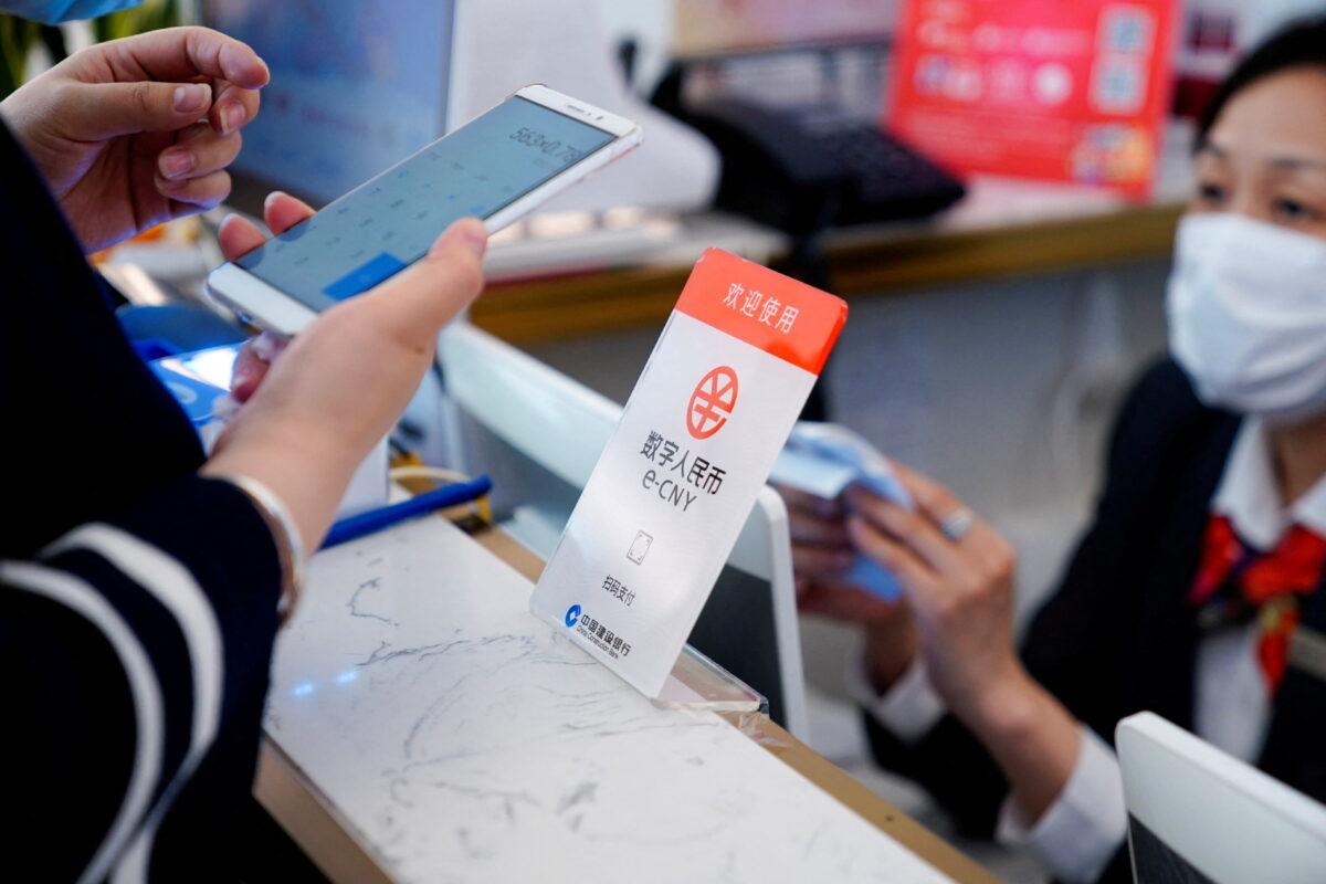 A sign indicating digital yuan, also referred to as e-CNY, is pictured at a shopping mall in Shanghai, China, on May 5, 2021. (Aly Song/Reuters)