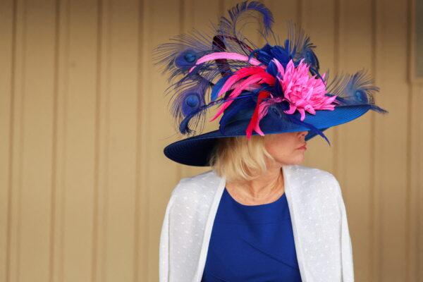 A spectator shows off her Derby hat on the day of the 148th Thurby, the Thursday before Kentucky Derby at Churchill Downs in Louisville, Ky., on May 5, 2022. (Amira Karaoud/Reuters)