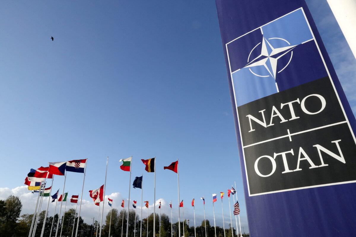 Flags wave outside the Alliance headquarters ahead of a NATO Defence Ministers meeting in Brussels, Belgium, on Oct. 21, 2021. (Pascal Rossignol/Reuters)