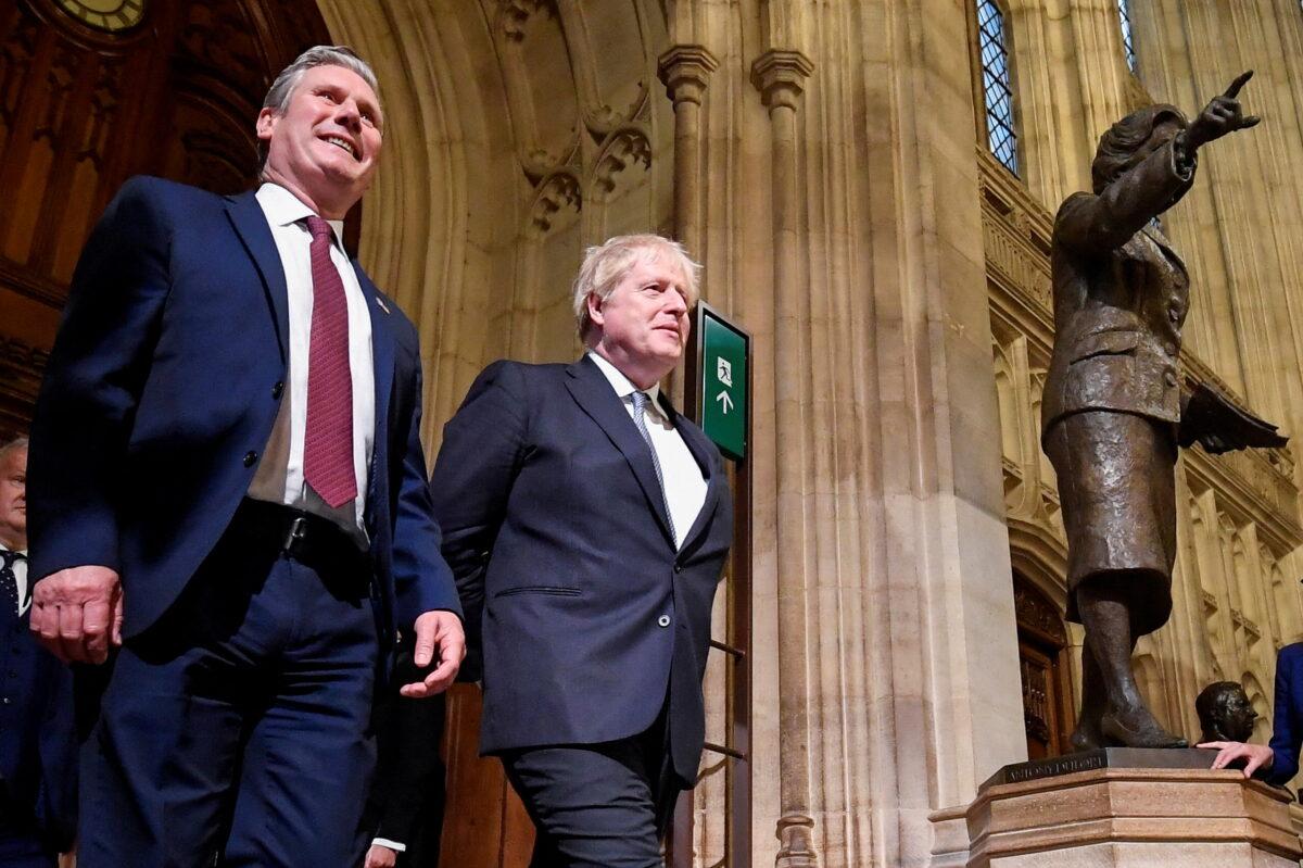 British Labour Party opposition leader Keir Starmer and Britain's Prime Minister Boris Johnson pass a statue of former Prime Minister Margaret Thatcher as they walk through the Members' Lobby following the State Opening speech of Parliament at the Palace of Westminster in London, on May 10, 2022. (Toby Melville - WPA Pool/Getty Images)