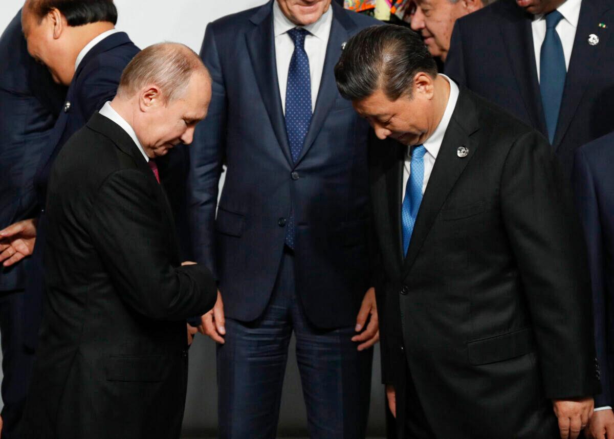 Russian President Vladimir Putin (L) and Chinese leader Xi Jinping before a photo session at the G20 summit in Osaka, Japan, on June 28, 2019. (Kim Kyung-Hoon-Pool/Getty Images)
