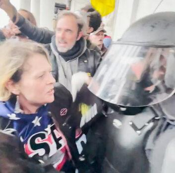 A woman hugs each of the 17 U.S. Capitol police officers rescued from the Capitol by the Oath Keepers on Jan. 6, 2021. (Rico La Starza, Archive.org/Screenshot via The Epoch Times)