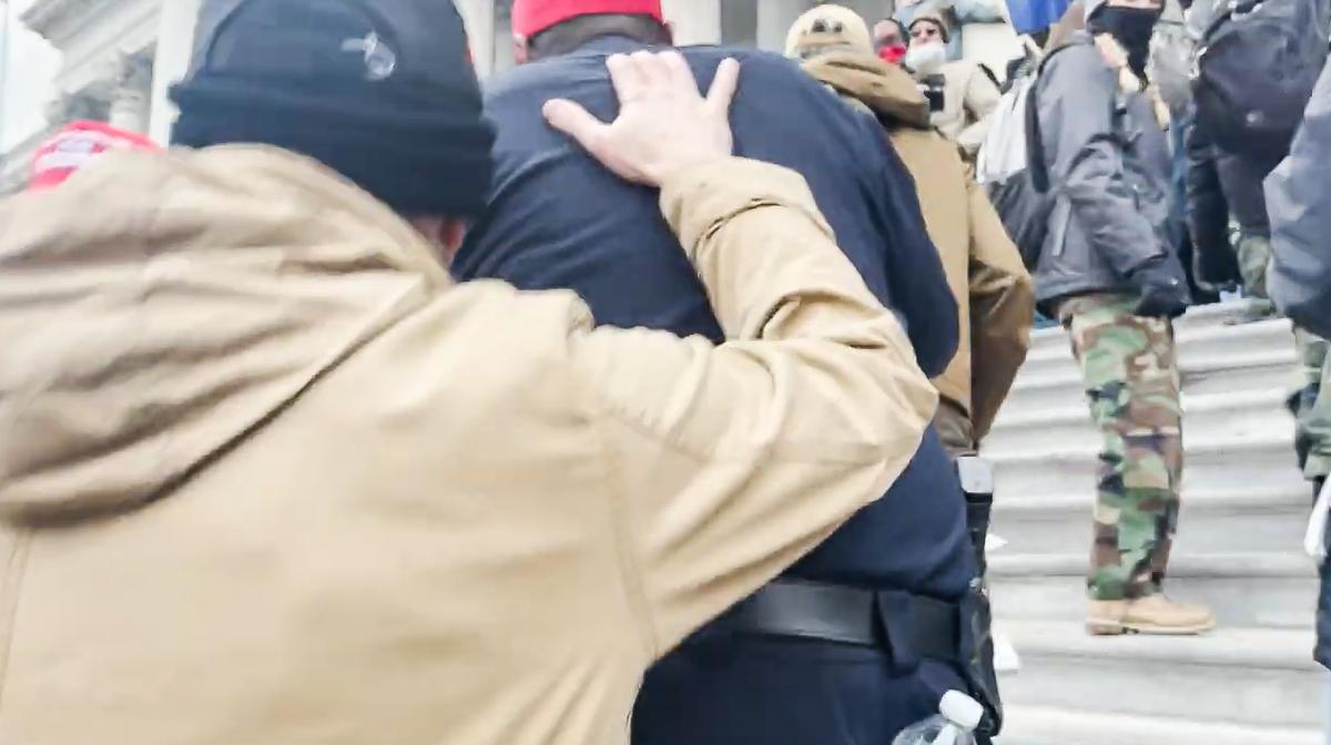 Two Oath Keepers and Capitol Police Lt. Tarik Johnson use a "stack formation" to ascend the crowded east steps of the U.S. Capitol on Jan. 6, 2021. (Rico La Starza, Archive.org/Screenshot via The Epoch Times)