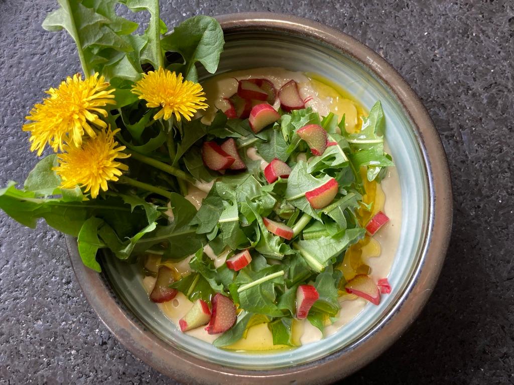 Creamy, tangy rhubarb hummus tames the bitter bite of dandelion greens in this nutrient-packed spring salad. (Ari LeVaux)