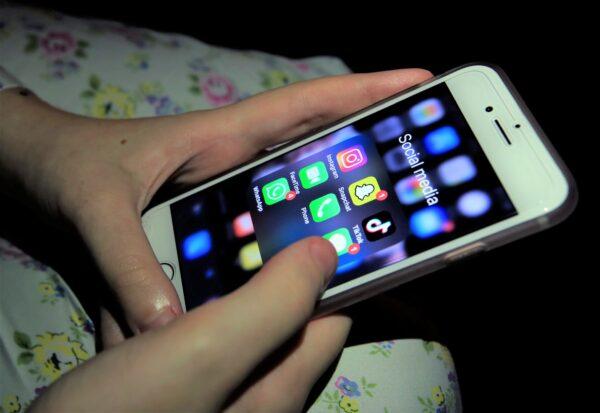 A young girl looking at social media apps, including TikTok, Instagram, Snapchat, and WhatsApp, on a smartphone on Nov. 12, 2019. (Peter Byrne/PA)