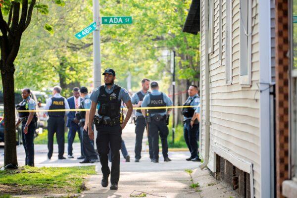 Chicago police work the scene of a fatal drive-by shooting in the 4800 block of South Ada Street, in the Back of the Yards neighborhood in Chicago on May 10, 2022. (Tyler Pasciak LaRiviere/Chicago Sun-Times via AP)