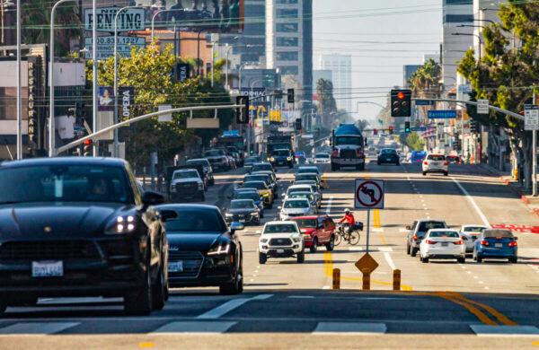 Cars and pedestrians travel in Los Angeles, Calif., on Nov. 10, 2021. (John Fredricks/The Epoch Times)