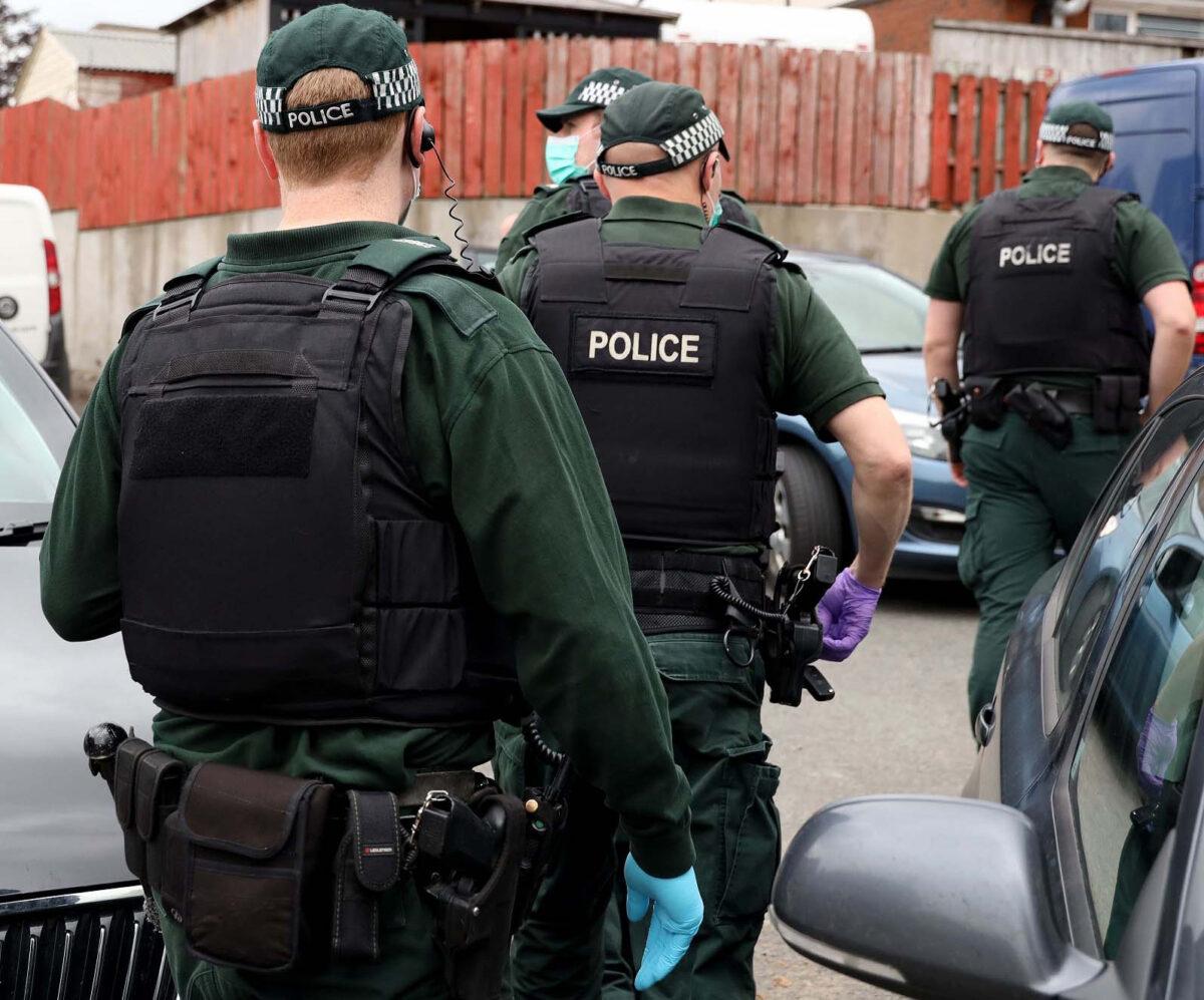 An undated handout photo issued by the Police Service of Northern Ireland of police during a raid in Operation Venetic, an investigation into EncroChat, an encrypted phone network. (Police Service of Northern Ireland/PA Media)