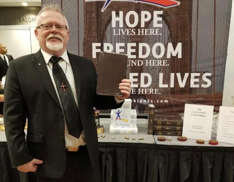 Randy Makinson poses in front of a Teen Challenge Ministry display table at the 60th annual Teen Challenge celebration in New York City in 2018. The ministry was created in 1958 as a result of outreach by Pastor David Wilkerson to troubled street youth in New York City. (Courtesy Kathy Makinson)