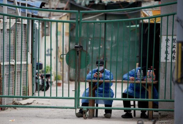 Security guards man a residential area under a COVID-19 lockdown in Beijing on May 11, 2022. (NOEL CELIS/AFP via Getty Images)