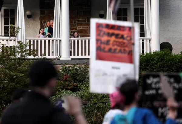 Residents watch as pro-abortion protesters demonstrate near the home of U.S. Supreme Court Chief Justice John Roberts in Chevy Chase, Maryland on May 11, 2022. (Kevin Dietsch/Getty Images)