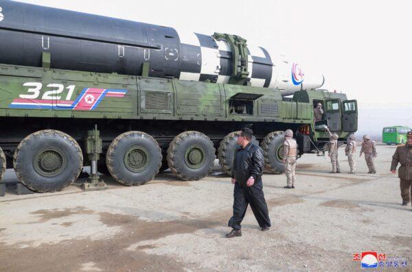 North Korean leader Kim Jong-un walks next to what state media reports is the "Hwasong-17" intercontinental ballistic missile (ICBM) on its launch vehicle in an undated photo released on March 25, 2022. (KCNA via Reuters)