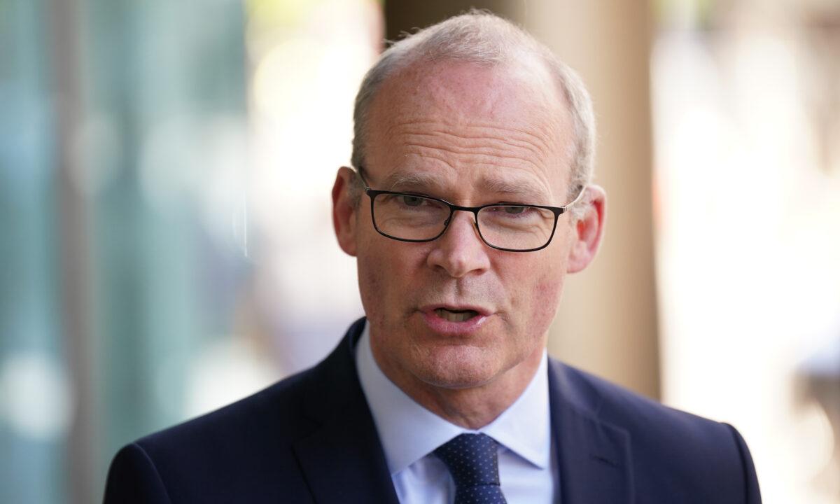 Irish Foreign Affairs Minister Simon Coveney speaking to the media outside Grand Central Hotel in Belfast, Northern Ireland, on May 11, 2022. (Rebecca Black/PA)