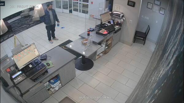 This surveillance video image released by the Fresno Police Department shows a man arriving at the hotel lobby to ask for a room in Fresno, Calif., on May 13, 2022. (Fresno Police Department via AP)