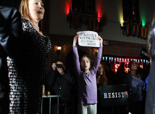 During a rally of transgender activists in New York City on Feb. 23, 2017, a boy who wants to be treated like a girl holds a sign begging to be able to use the girls' bathroom. (Spencer Platt/Getty Images)