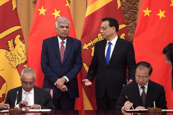 A file image of Sri Lankan Prime Minister Ranil Wickremesinghe (back, L) talking with Chinese Premier Li Keqiang (back, R) during a signing ceremony at the Great Hall of the People in Beijing on May 16, 2017. (Nicolas Asfouri/Getty Images)