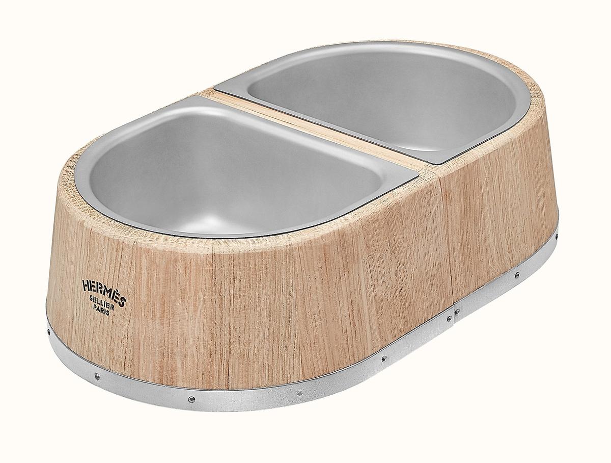 A combination water and food bowl accented in hand-crafted wood is a stylish way to keep your pet well-hydrated and well-fed. (Courtesy of Hermes)