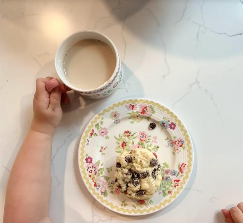 One of the author's daughters enjoys a chocolate chip scone and a hot cuppa. (Rachael Dymski)
