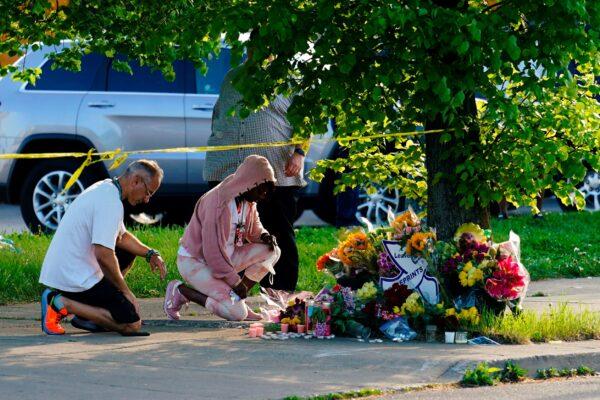 People pay their respects outside the scene of a shooting at a supermarket in Buffalo, N.Y., on May 15, 2022. (Matt Rourke/AP Photo)