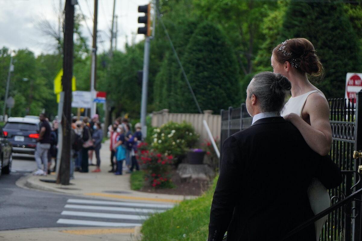 Pro-abortion protesters run into a pair of newlyweds in the neighborhood of Justice Brett Kavanaugh and Justice John Roberts in Chevy Chase, Md., on May 15, 2022. (Jackson Elliott/The Epoch Times)