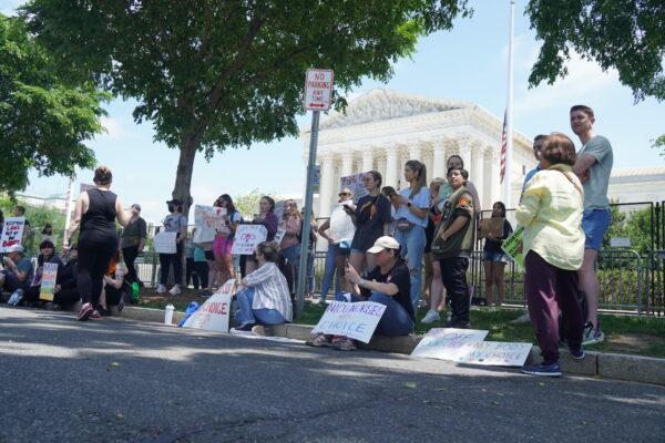 Pro-abortion protesters, including one with a Communist arm patch, protest outside the U.S. Supreme Court in Washington, D.C. on May 15, 2022 (Jackson Elliott/The Epoch Times)