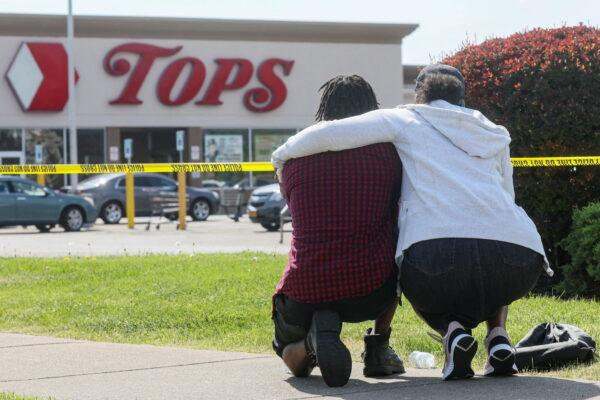 Mourners react while attending a vigil for victims of the shooting at a Tops Friendly Market in Buffalo, N.Y., on May 15, 2022. (Brendan McDermid/Reuters)