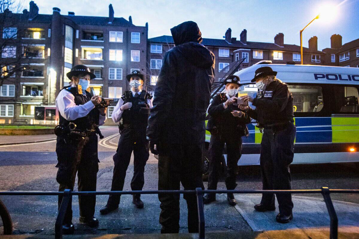 Police speak to a young man in London in an undated file photo. (Victoria Jones/PA)