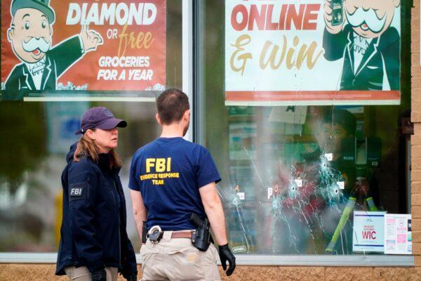 Investigators work the scene of a shooting at a supermarket in Buffalo, N.Y., on May 16, 2022. (Matt Rourke/AP Photo)