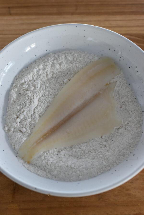 Dredge the fish fillets in seasoned flour. (Audrey Le Goff)