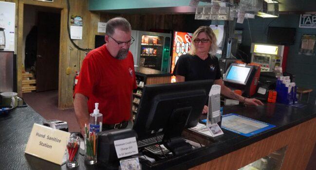 Brian and Mindy Hill work the counter at their bowling alley in Imlay City, Mich., on May 13, 2022. (Steven Kovac/Epoch Times)