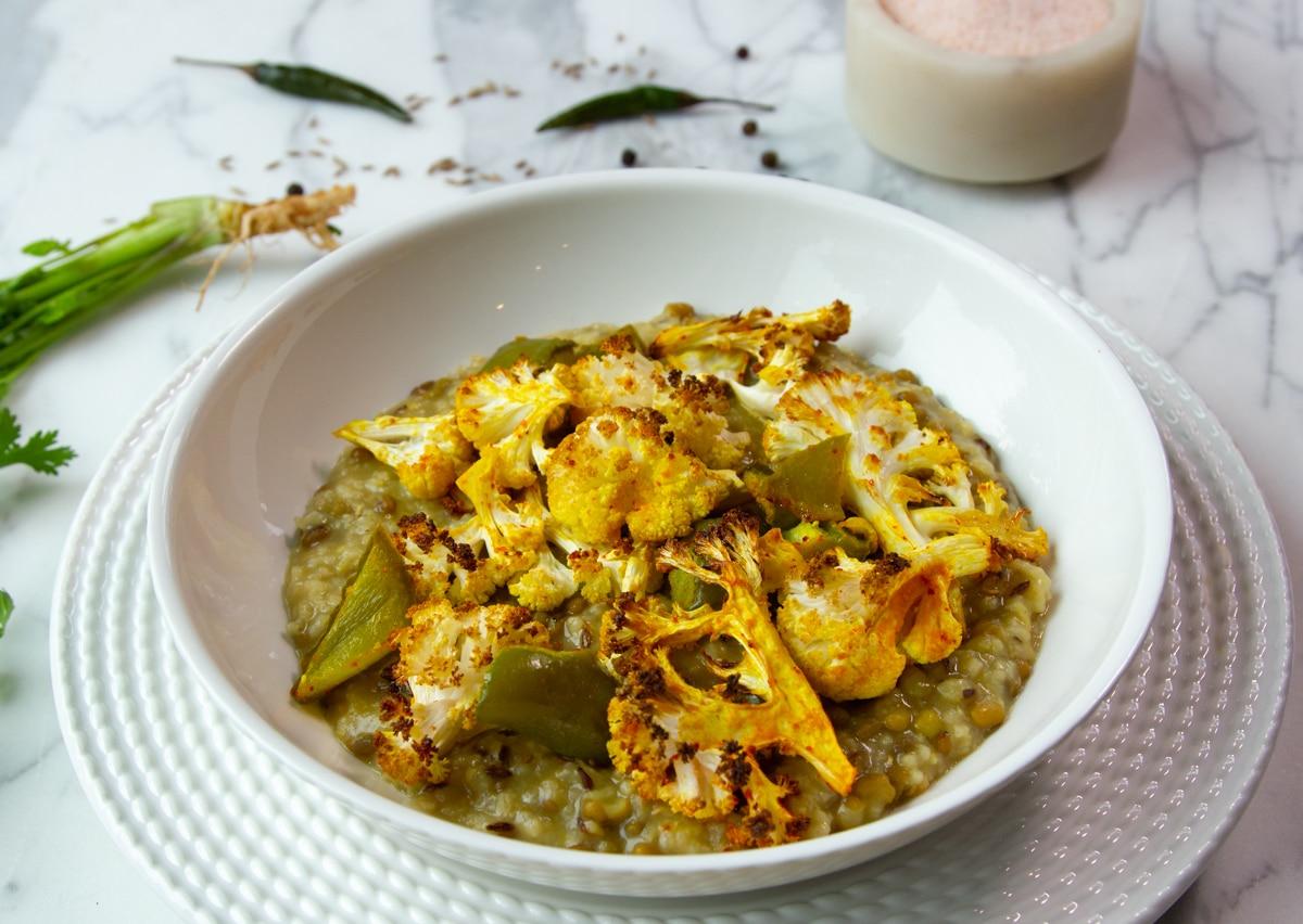 Khichdi with a roasted cauliflower and green pepper topping dusted with turmeric. (Courtesy of ButteredVeg.com)