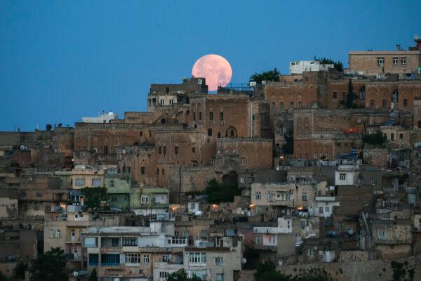 A full moon above the historical city center of Mardin, famous with its stone houses, in southeastern Turkey, on May 16, 2022. (Emrah Gurel/AP Photo)
