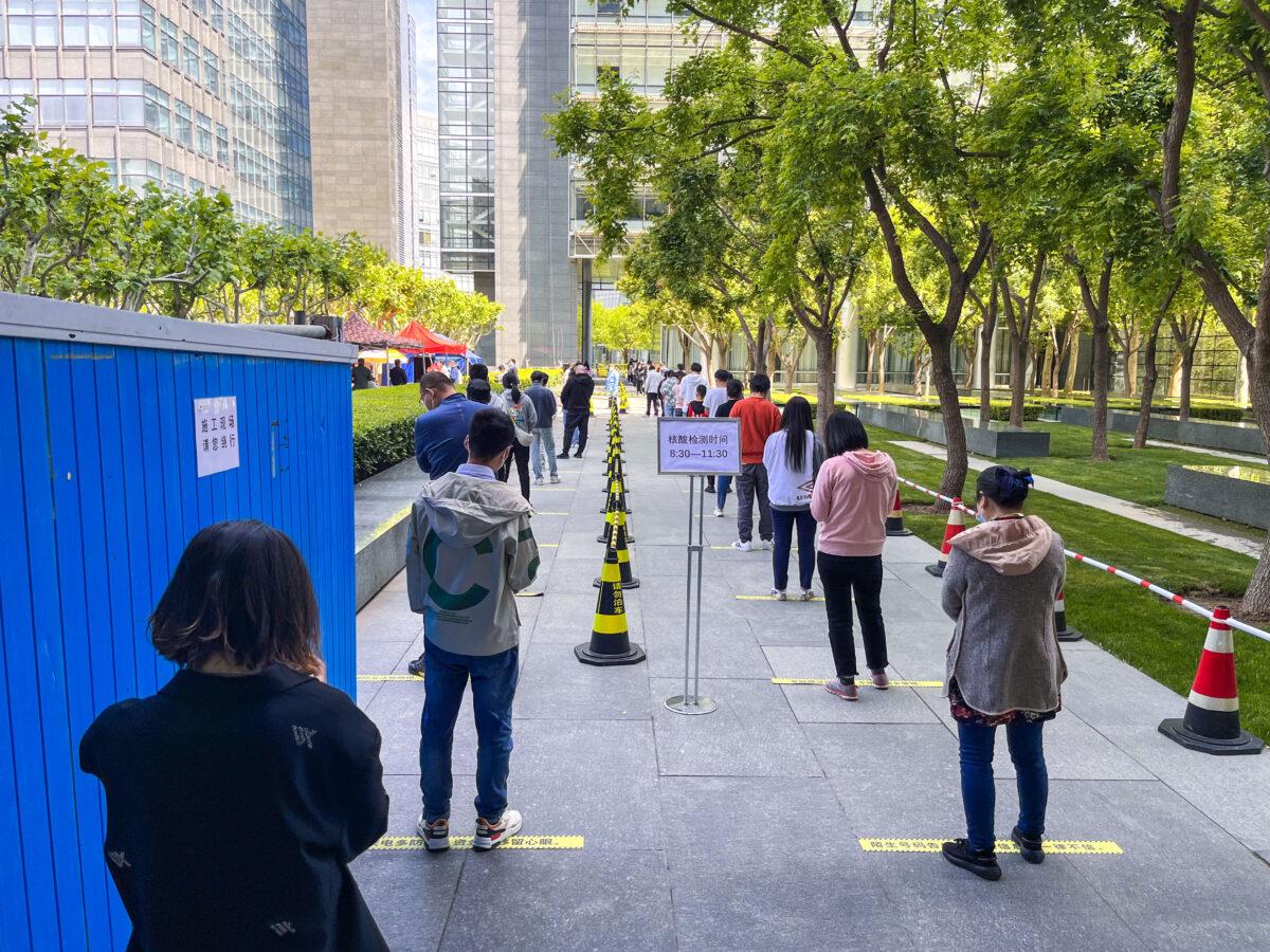 People queue up for COVID-19 nucleic acid tests during a new round of nucleic acid testing amid the COVID-19 resurgence in Beijing, China, on May 11, 2022. (VGC/VCG via Getty Images)
