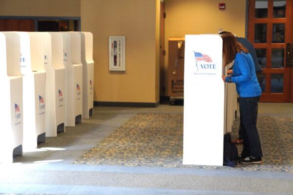 A voter casts her ballot during Idaho's May 17 primary at a polling location in the state capital Boise. (Allan Stein/The Epoch Times)