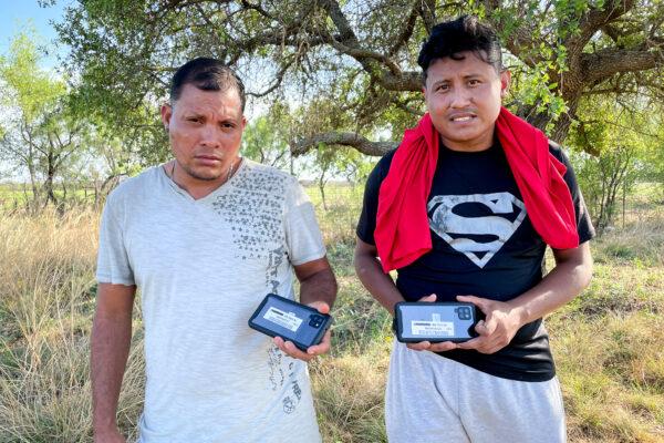 Two Nicaraguan nationals hold up the cellphones they received from Border Patrol before being released into the United States, in Kinney County, Texas, on April 29, 2022. (Charlotte Cuthbertson/The Epoch Times)