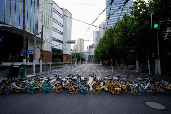 Bicycles from a bike-sharing service block a street during lockdown in Shanghai on May 16, 2022. (Aly Song/Reuters)