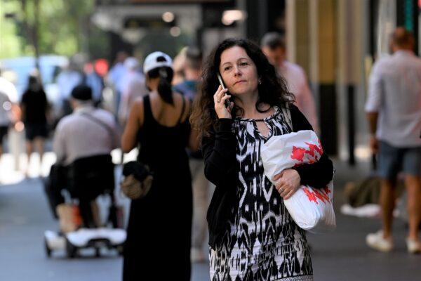A shopper holds a retail bag in Pitt St Mall, Sydney, Australia, on Feb. 1, 2022. (AAP Image/Bianca De Marchi)