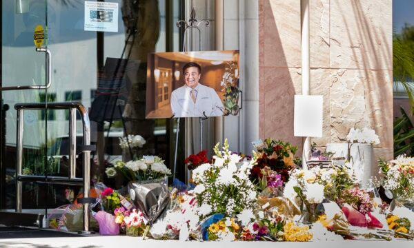 A memorial site for shooting victim Dr. John Cheng, whose photo sits on display at the entrance of South Bay Medical Group in Aliso Viejo, Calif., on May 17, 2022. (John Fredricks/The Epoch Times)