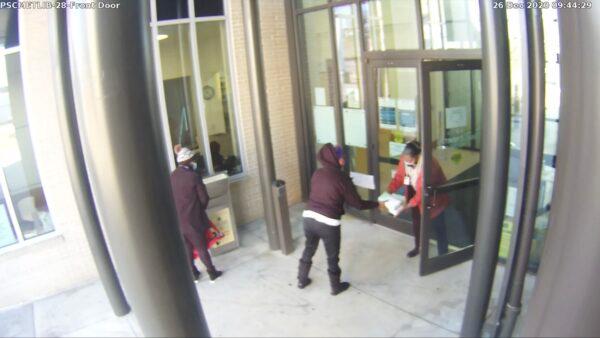 A still frame from surveillance footage of a ballot drop box at a library in Atlanta. True the Vote officially has asked Georgia officials to investigate what seems to show ballots being passed between an election worker and an unknown library staffer. (Courtesy of True the Vote)