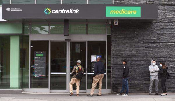 People queue outside an Australian government welfare centre, Centrelink, in Melbourne, Australia, on March 23, 2020. (William West/AFP via Getty Images)