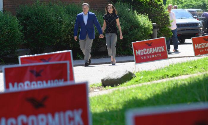 Then-Republican Senatorial Candidate David McCormick and his wife Dina Powell McCormick head to vote on the campus of Chatham University in Pittsburgh, Pa. on May 17, 2022. (Jeff Swensen/Getty Images)