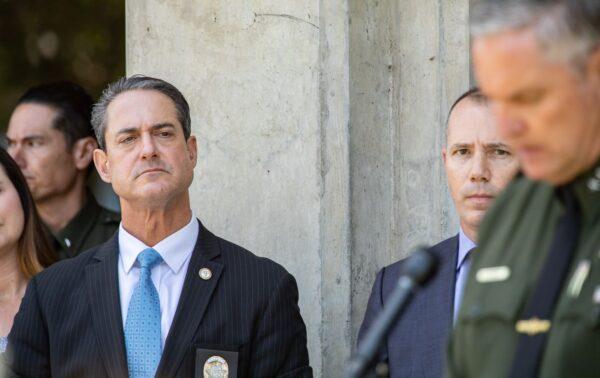 Orange County District Attorney Todd Spitzer listens to Sheriff Don Barnes during a press briefing on a May 15 Laguna Woods, Calif., church shooting in Santa Ana, Calif., on May 16, 2022. (John Fredricks/The Epoch Times)