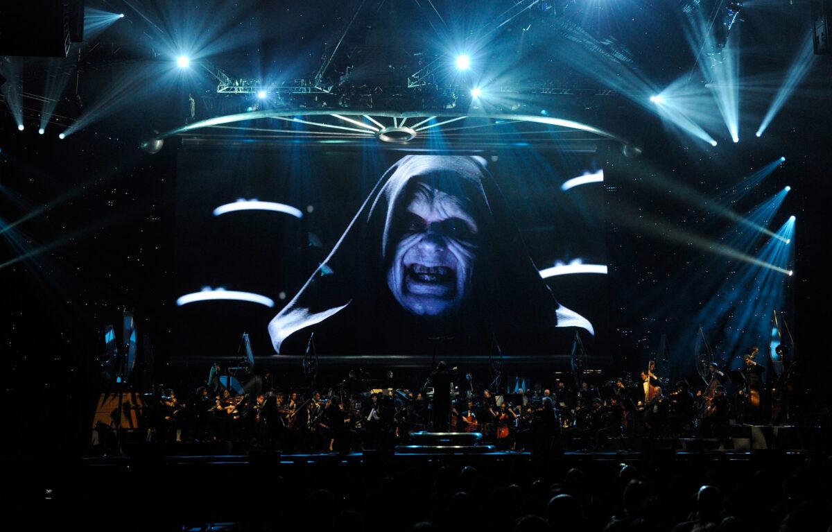 Actor Ian McDiarmid's Emperor Palpatine character from the Star Wars film series is shown on screen while musicians perform "Star Wars: In Concert" at the Orleans Arena in Las Vegas, Nevada on May 29, 2010. (Ethan Miller/Getty Images)