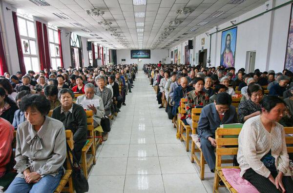 Christians pray during a mass at a church in Xining, Qinghai Province, northwest China, on July 3, 2005. China officially sanctions five religious groups: Protestant and Catholic Christianity, Islam, Buddhism, and Taoism. The Chinese are allowed to worship only in state-sanctioned churches and temples. (China Photos/Getty Images)