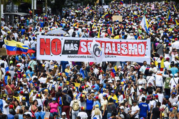 Opposition supporters hold a banner reading "No More Socialism" during a gathering with Venezuelan opposition leader Juan Guaidó, in Caracas, Venezuela, on Feb. 2, 2019. (Juan Barreto/AFP via Getty Images)